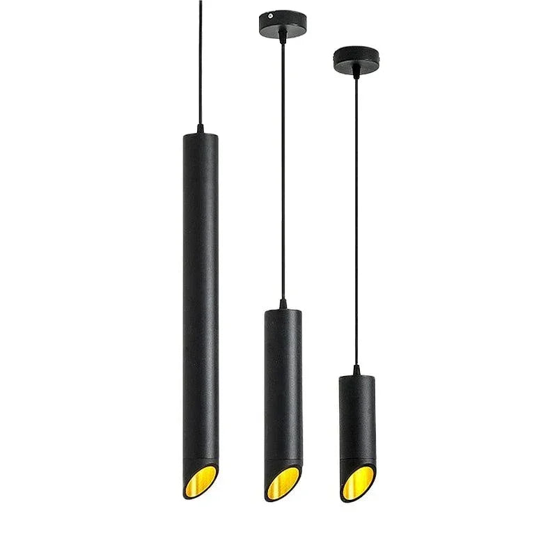 Three modern black cylindrical pendant lights with yellow interior, hanging at different heights