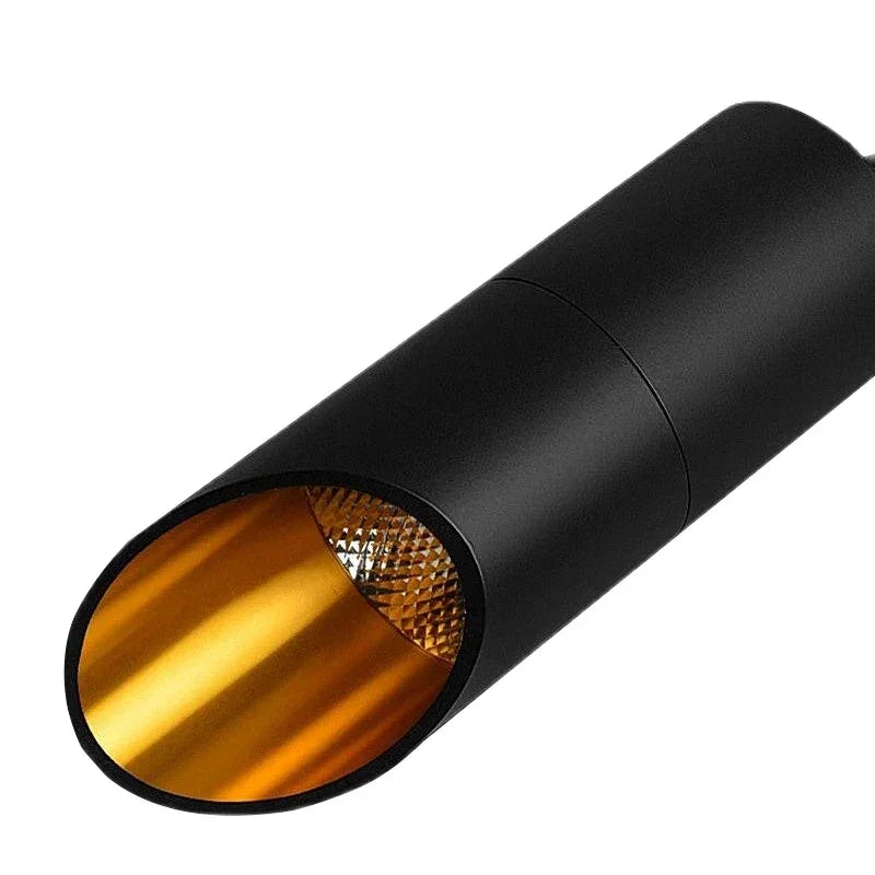 Black cylindrical spotlight with gold reflective interior for modern home lighting
