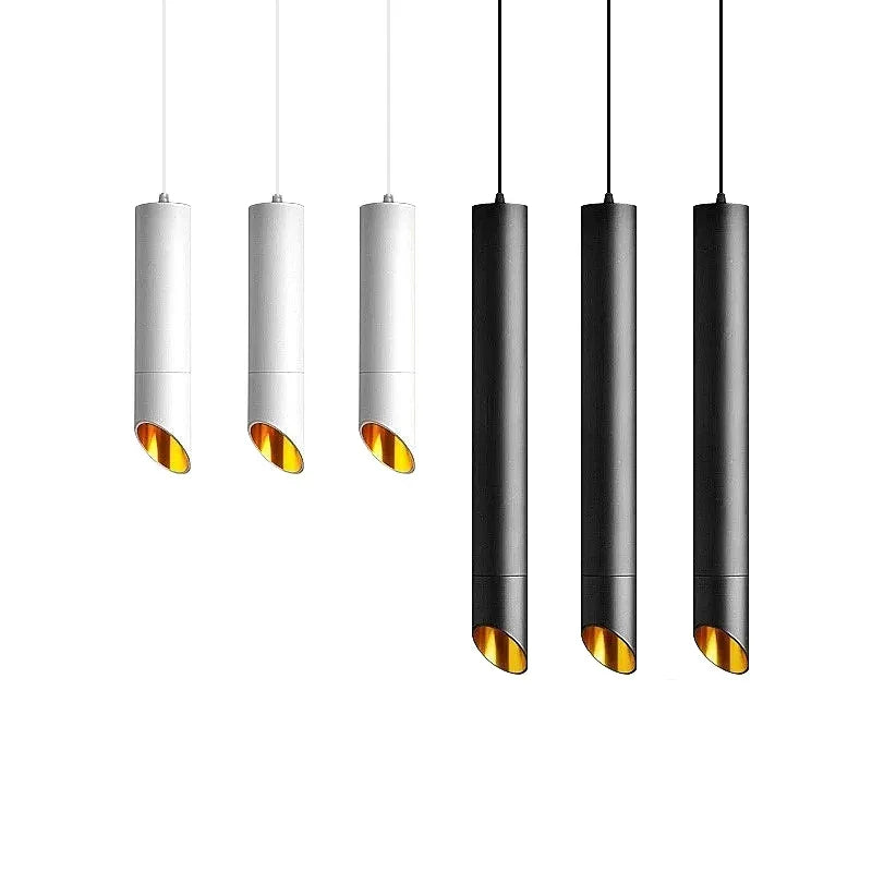 Set of minimalist black and white cylindrical pendant lights with angled golden interior, modern home lighting