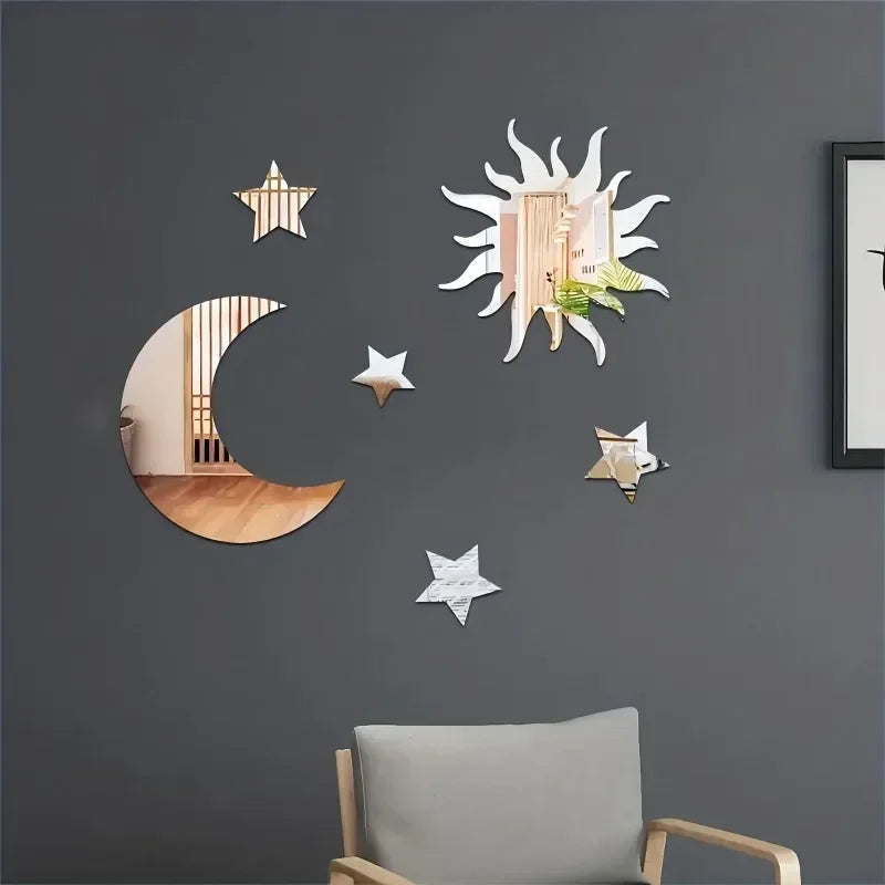 Decorative sun, moon, and star-shaped mirror wall art on dark gray wall above light gray armchair