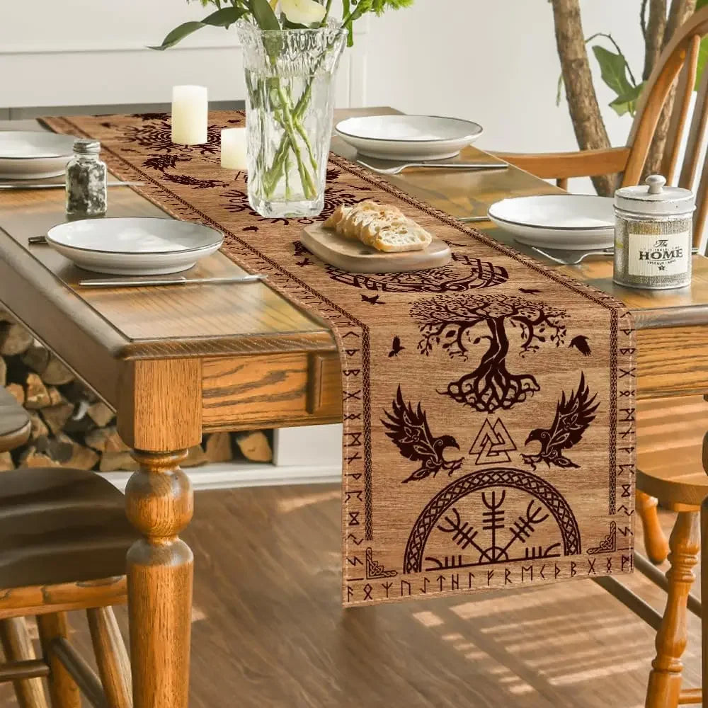 Wooden dining table with Nordic-inspired table runner featuring tree of life and runes, set with plates and bread