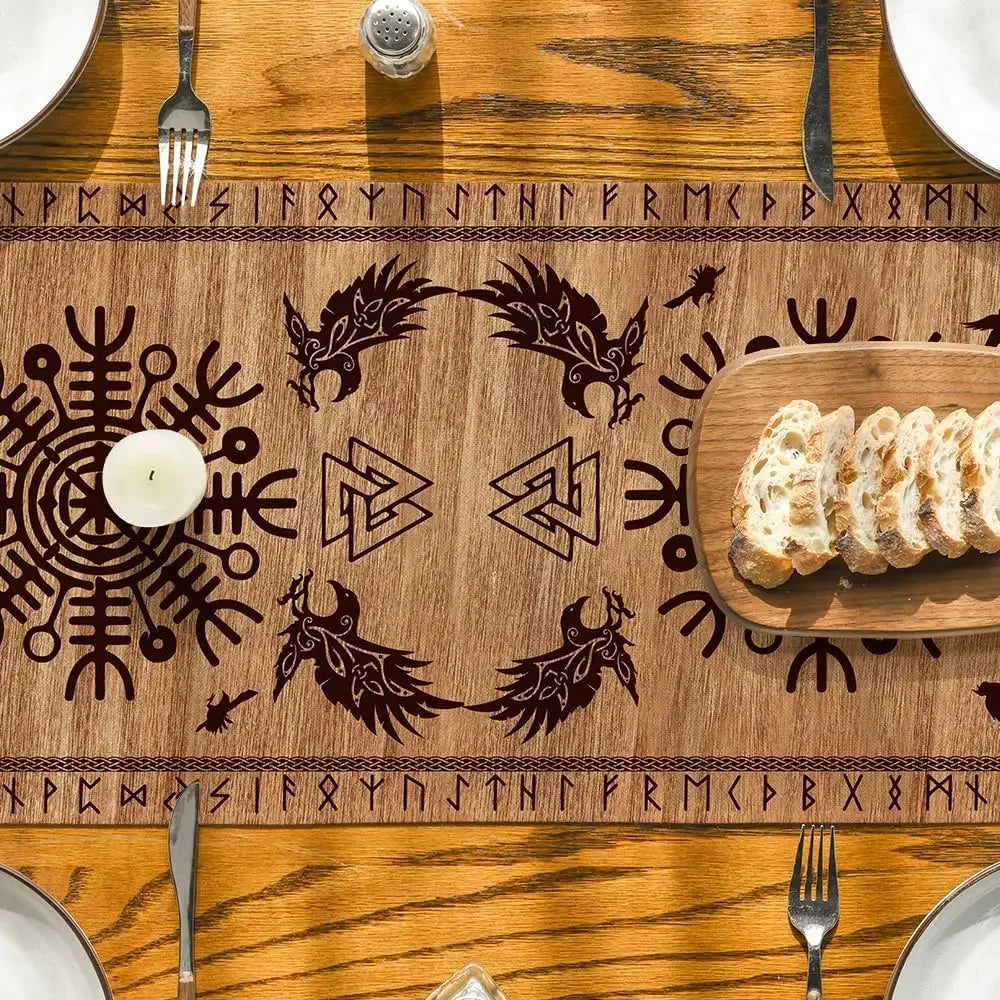 Rustic wooden table with Viking-themed table runner featuring runes, ravens, and a candle, with sliced bread on a cutting board