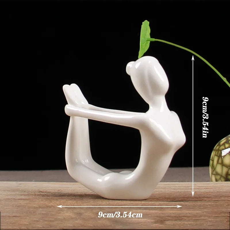 White ceramic yoga figure sculpture in bow pose on wooden surface, minimalist modern home decor