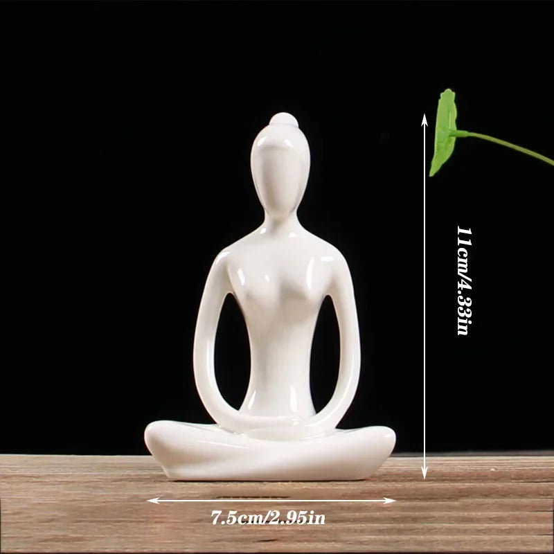 Minimalist white ceramic yoga meditation statue sitting cross-legged on wooden surface, 11cm tall