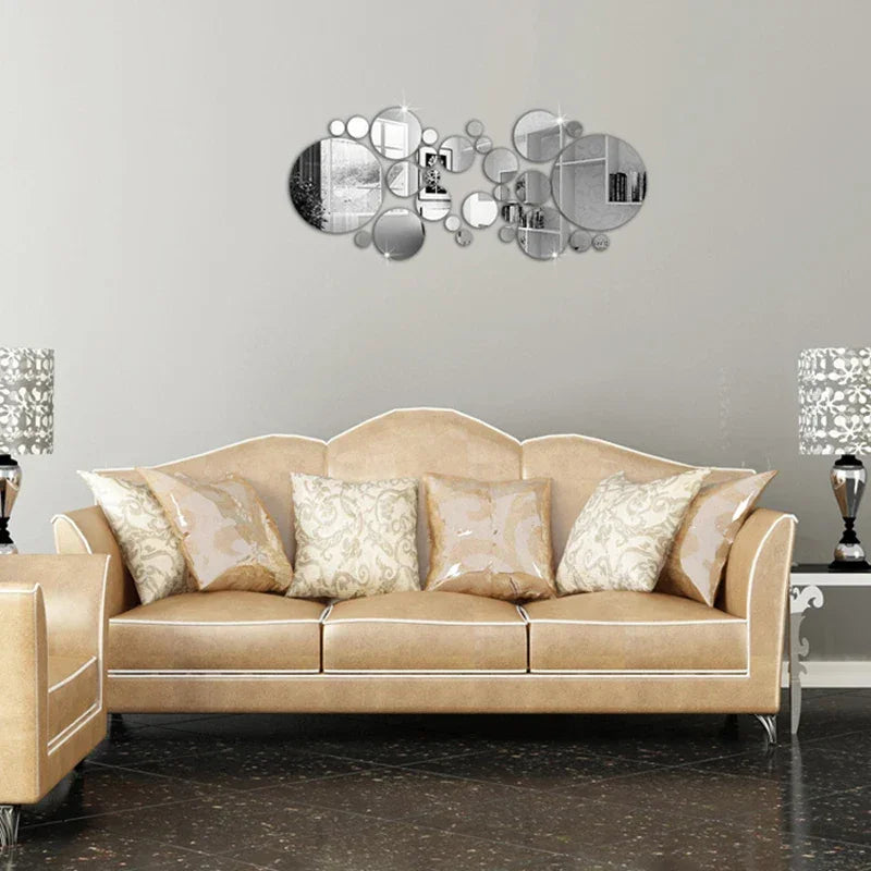 Beige sofa with decorative patterned cushions and modern circular mirrors on gray wall in living room
