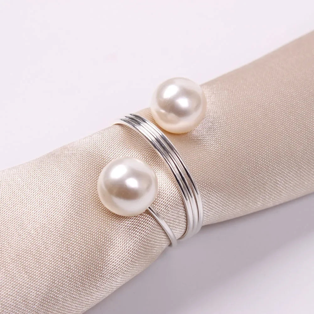 Silver double pearl napkin ring on beige textured fabric, elegant table decor accessory