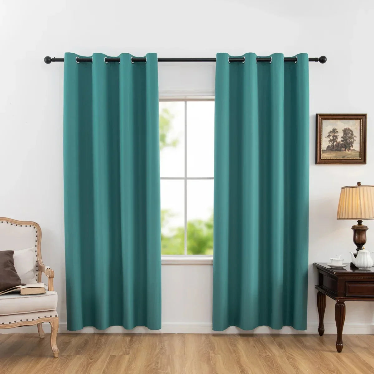 Teal blue blackout curtains hanging on black rod in a cozy living room with wooden floor