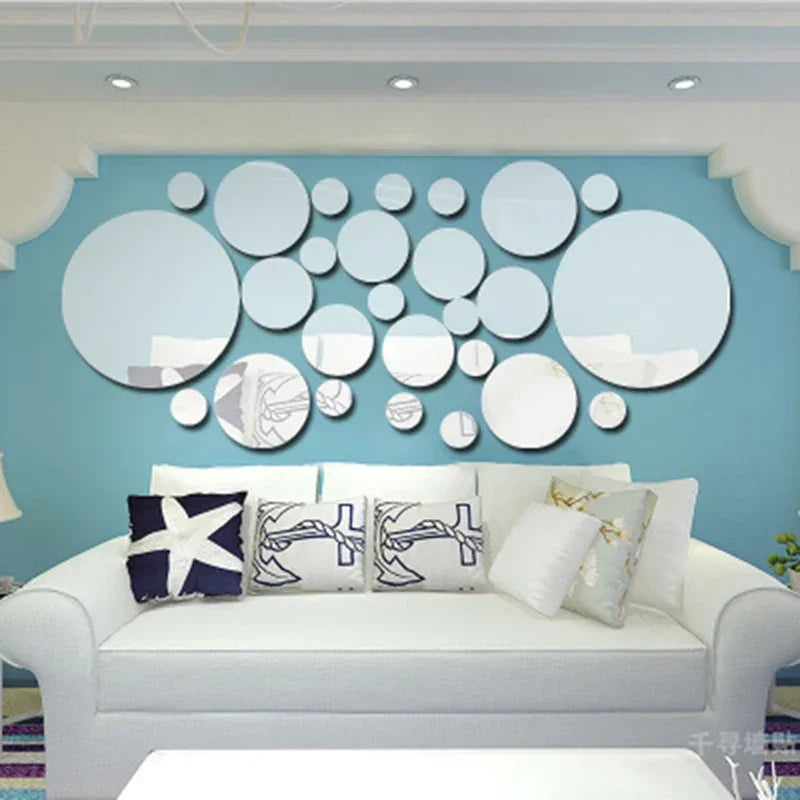 Modern living room with white sofa, nautical-themed pillows, and round decorative mirrors on blue wall