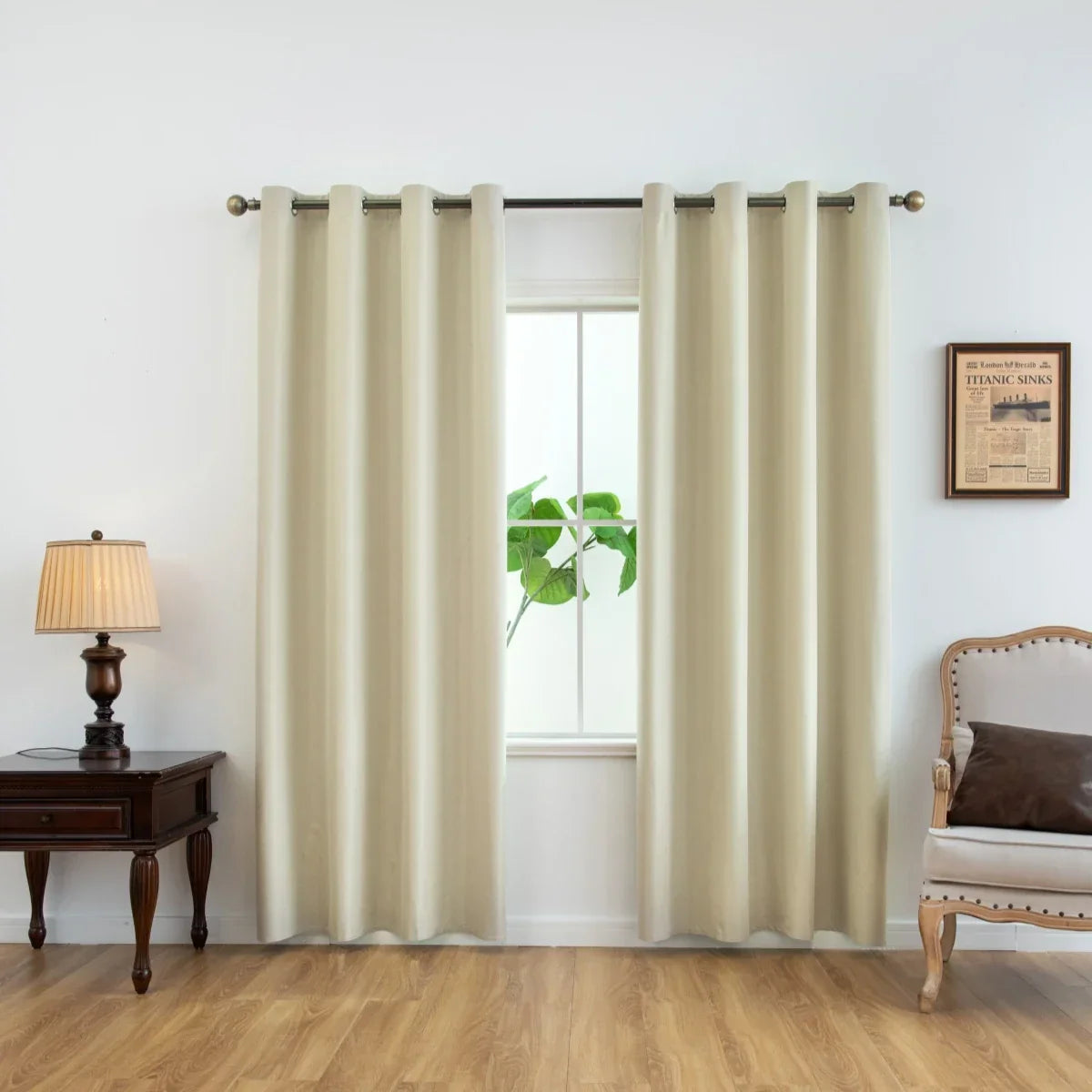 Elegant beige curtains hanging on a window with wooden floor, classic armchair, side table, and lamp